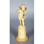 A GOOD EUROPEAN CARVED IVORY CUPID standing on a plinth. 6ins high.