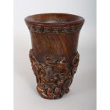 A TALL CHINESE CARVED HORN LIBATION CUP, depicting scrolling animals. 6ins high.