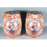 A PAIR OF OCTAGONAL IMARI POTTERY GARDEN SEATS decorated with foliate motifs. 18ins high.