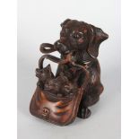A BLACK FOREST CARVED WOOD DOG WITH CUBS IN A BASKET INKWELL.