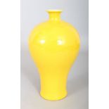 A CHINESE YELLOW PORCELAIN BALUSTER VASE, with seal to base. 9ins high.