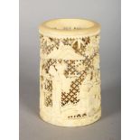 A CHINESE CANTON CARVED IVORY BRUSH POT, carved and pierced with figures and trees. 3.25ins high x