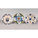 THREE POLYCHROME DUTCH DELFT PLATES, MID-LATE 18TH CENTURY, boldly painted in blues, iron-reds,