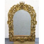 A GOOD 18TH CENTURY ITALIAN CARVED AND GILDED MIRROR, the frame carved with four winged cupids,