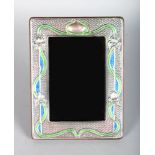 A STERLING SILVER AND ENAMEL PHOTOGRAPH FRAME. 7.5ins x 5.5ins.