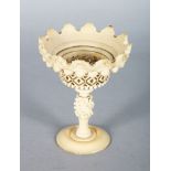 A CARVED IVORY AND PIERCED PEDESTAL TAZZA. 4ins high.
