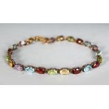 A GOLD MULTI-COLOUR STONE BRACELET.