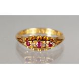 AN 18CT GOLD, DIAMOND AND RUBY DRESS RING.