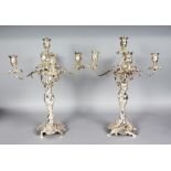 A GOOD PAIR OF SILVER PLATED FOUR BRANCH CANDELABRA with acanthus scrolling branches. 19ins high.
