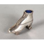 A SILVER NOVELTY PAIR OF SKATES PIN CUSHION.