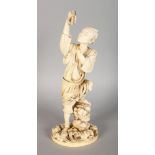 A CHINESE CARVED IVORY FIGURE OF A FISHERMAN holding a fish. Signed. 11ins high.