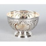 A SMALL VICTORIAN CIRCULAR ROSE BOWL, with floral repousse decoration and scrolls. 4.5ins