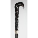 A CEYLONESE SILVER MOUNTED EBONY WALKING STICK.