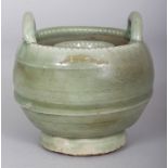 A CHINESE MING STYLE LONGQUAN CELADON STONEWARE CANDLE HOLDER, with double upright lug handles, 4.