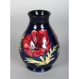 A MOORCROFT ANEMONE VASE on a blue ground. 5ins high.