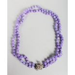 A GOOD STRING OF LAVENDER JADE BEADS with diamond clasp.