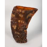 A TALL CHINESE CARVED HORN LIBATION CUP, depicting figures in a landscape, bears stamp to the