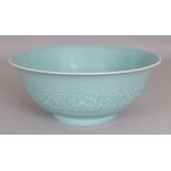 A GOOD QUALITY CHINESE CELADON PORCELAIN BOWL, the sides moulded in relief beneath the glaze with