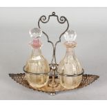 A BOAT SHAPED TWO BOTTLE CRUET, with a pair of cut glass bottles. Maker: J.D. & S. Sheffield 1895.