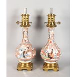 A VERY GOOD PAIR OF 19TH CENTURY IMARI BOTTLE VASES, with gilt metal mounts and bases as LAMPS.