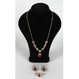 A SILVER AND GILT RUBY SET NECKLACE, RING AND EARRINGS.