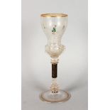 AN EARLY GERMAN GLASS GOBLET, painted with European and Chinese figures, (the stem with metal