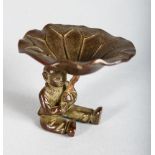A SMALL CHINESE BRONZE, a boy holding a lily pad. 2ins high.
