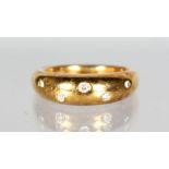 AN 18CT GOLD DIAMOND SET GYPSY RING.