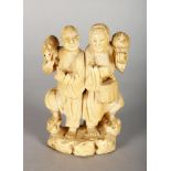 A JAPANESE IVORY GROUP OF TWO MEN. 4ins high.