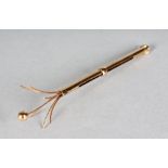 A 9CT GOLD SWIZZLE STICK.