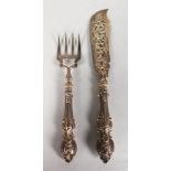 A PAIR OF VICTORIAN FISH SERVERS, with ornate cast handles, engraved and pierced blades. Maker: