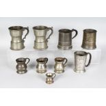 A GROUP IF NINE 18TH-19TH CENTURY PEWTER TANKARDS AND MEASURES (9). 5ins high and smaller.