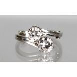 A SUPERB TWO STONE DIAMOND CROSSOVER RING in 18ct white gold.