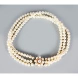 A VERY GOOD THREE STRAND PEARL CHOKER with 18ct yellow gold, pearl and diamond set clasp.