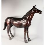 A LARGE BRONZE STANDING HORSE. 3ft 4ins high x 3ft 10ins long.