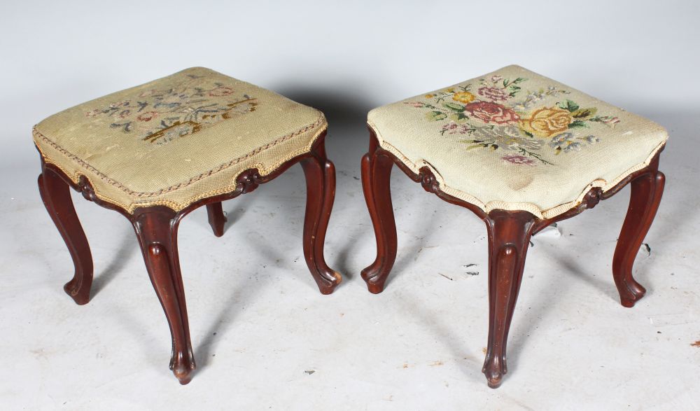 A PAIR OF VICTORIAN SQUARE PADDED STOOLS, with needlework top on cabriole legs.