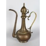 AN EARLY PERSIAN BRASS EWER etched with ovals of figures etc. 14ins high.