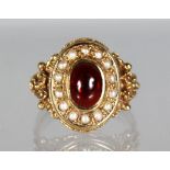 A GOLD DRESS RING with seed pearls and cabochon ruby.