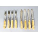 A SET OF FOUR VICTORIAN CARVED HANDLED FISH KNIVES AND FORKS. Sheffield 1900.