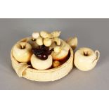 A SUPERB CARVED IVORY GROUP OF VARIOUS FRUITS IN A BASKET. 6ins long.