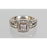 A 14CT WHITE GOLD RING, with central Princess cut stone flanked by diamond shoulders, 1ct total