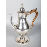 A VERY GOOD GEORGE III NEWCASTLE COFFEE POT AND COVER with engraved decoration and wooden handle.