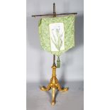 A 19TH CENTURY BANNER SCREEN on gilt tripod base.