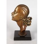 AN ART DECO BRONZE FEMALE HEAD, on a square black marble base. 7ins high.