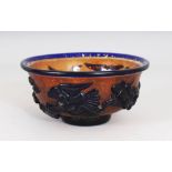 A CHINESE PEKING GLASS BOWL, decorated with blue storks and floral designs. 5ins diameter.
