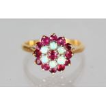 AN 18CT GOLD, RUBY AND DIAMOND CLUSTER RING.