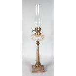 A COLUMN OIL LAMP on a square shaped base. 20ins high.