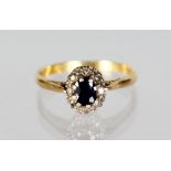 A 9CT GOLD OVAL CLUSTER RING.