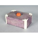 AN UNUSUAL MAUVE COLOURED SHAGREEN IVORY BOX AND COVER with coral handle. 4ins wide.