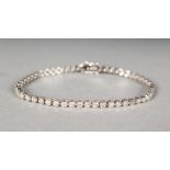 AN 18CT WHITE GOLD DIAMOND TENNIS BRACELET, made up of 3cts of brilliant cut stones.